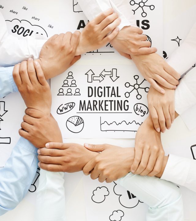 Unity and teamwork Business team making ring of hands above digital marketing drawing